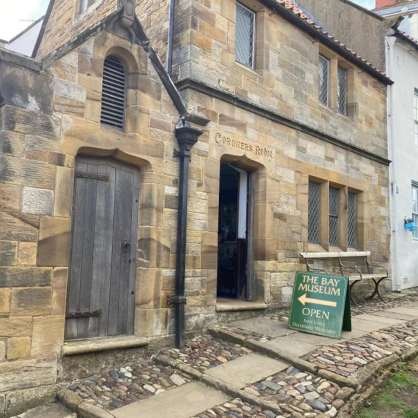 Stone building with a sign reading 
